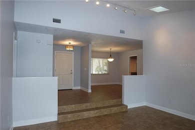 View from living room to front entrance and dining