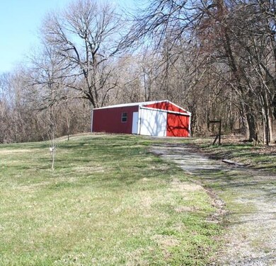 24x30 metal shop with concrete floor and electricity on back of property