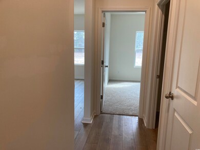Hall featuring wood-type flooring, baseboards, and