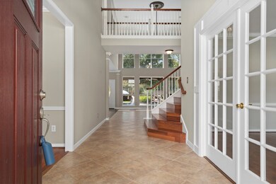 As you enter you will be greeted with a large entry way and high vaulted ceilings