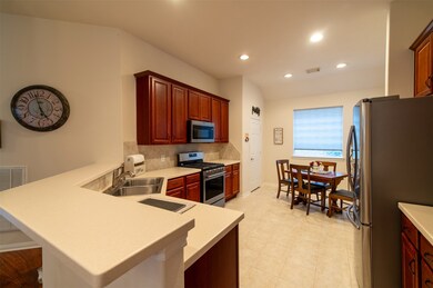 34 S Dylanshire Cir Kitchen boast white Corian counter tops! So easy to keep clean! Rich Cherry Wood Stained cabinets are plentiful in this kitchen!