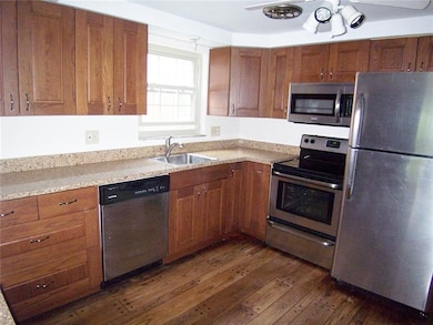 Rich wood cabinetry is new, granite countertops, a