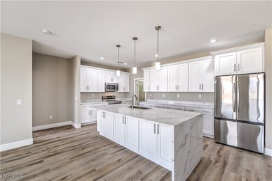 Kitchen featuring white cabinets, light wood finis