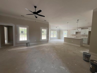 Unfurnished living room featuring healthy amount of natural light, ceiling fan, baseboards, and recessed lighting