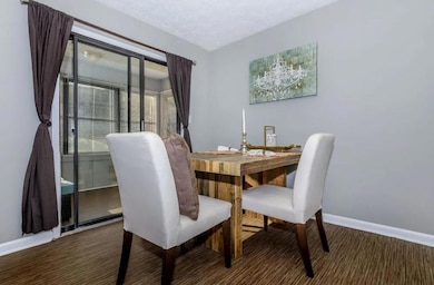 Dining room with dark hardwood / wood-style floori