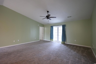Spare room with vaulted ceiling, dark colored carp