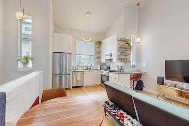 Kitchen featuring stainless steel appliances, ope