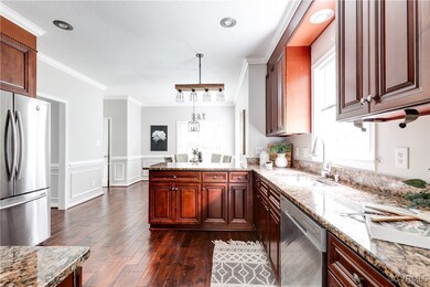 Experience this beautifully updated kitchen, featuring rich wood cabinetry, gleaming granite countertops, and modern stainless steel appliances, all designed for both style and functional living