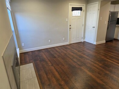 Foyer featuring dark wood finished floors and bas