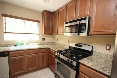 Kitchen with stainless steel appliances, a sink, b