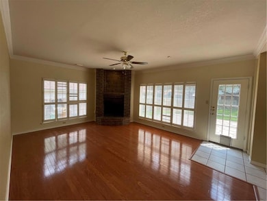Unfurnished living room featuring a ceiling fan, 