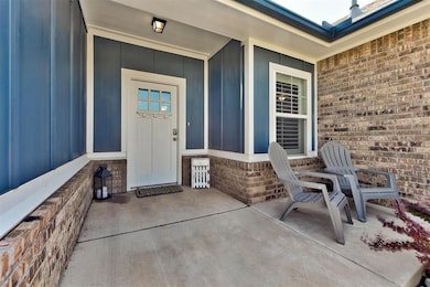 Entrance to property featuring brick siding