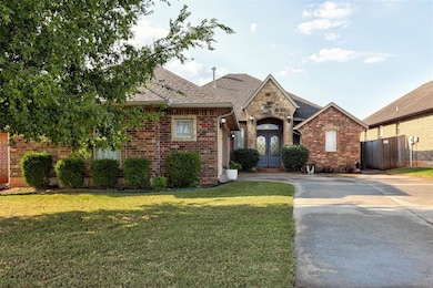 View of front of property featuring brick siding, a shingled roof, and driveway