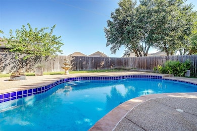 View of swimming pool featuring a fenced backyard.