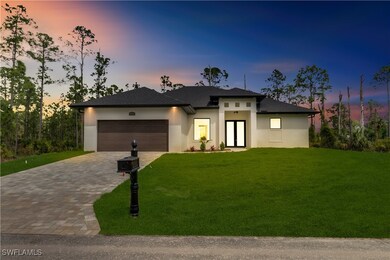 Prairie-style house featuring a garage, a yard, de