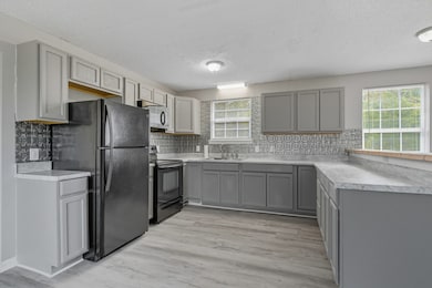 Updated Kitchen with abundant cabinet and counter space.  All Kitchen Appliances remain.