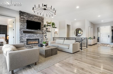 Luxury low maintenence LVP floors on the main floor, floor to ceiling stacked stone fire place, custom lighting in this great room