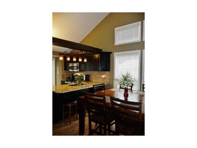 Updated kitchen with hardwoods and granite.