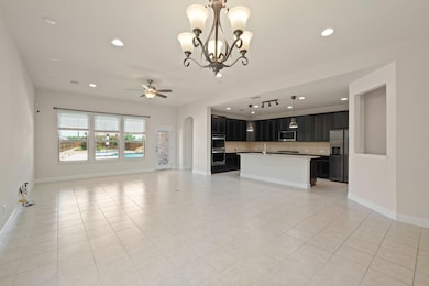 Unfurnished living room featuring a ceiling fan, 