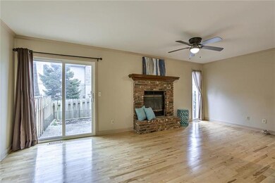 Family room has beautiful hardwood floor and brick wood burning fireplace.