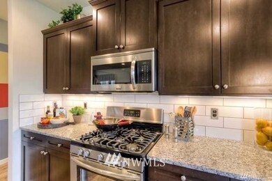 Kitchen with granite countertops and gas stove