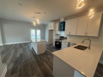 Kitchen featuring range, white cabinets, french doors, dark wood-style flooring, and dishwashing machine