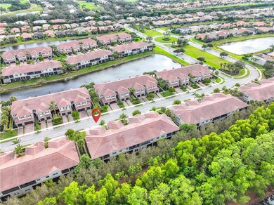Birds eye view of property with a water view