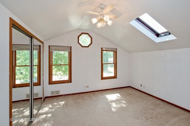 SECOND BEDROOM WITH VAUTLED CEILINGS AND SKYLIGHT