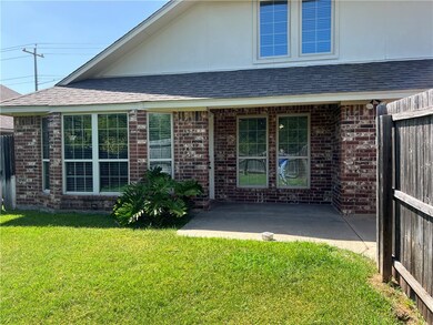 Rear view of house featuring a lawn and a patio area