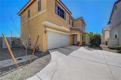 View of side of home with a garage, driveway, a ti