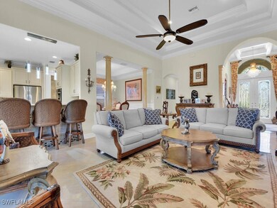 Living room featuring a tray ceiling, ornamental m