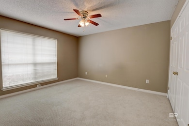 Spare room with ceiling fan, a healthy amount of sunlight, and carpet flooring