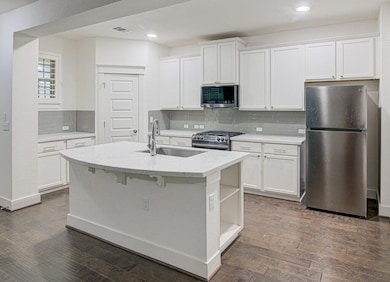 Kitchen featuring dark wood finished floors, a si
