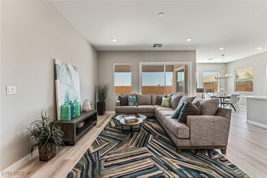 Living room featuring a chandelier, light wood finished floors, baseboards, and recessed lighting
