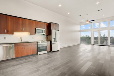 Open-concept living + dining with brand new LVP modern flooring, fully repainted, and a perfect seamless flow.