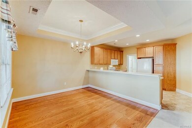 Dining Room with Hardwood Floors, Chandelier and T