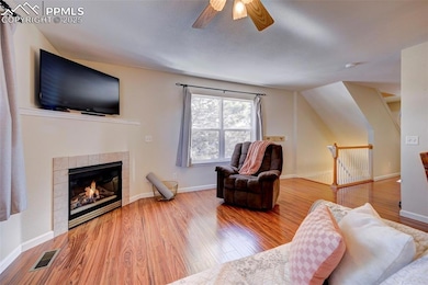 Living room featuring a tile fireplace, hardwood /