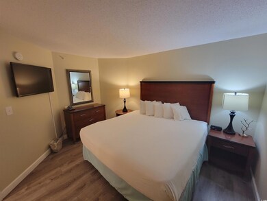 Bedroom featuring wood finished floors and a textured ceiling