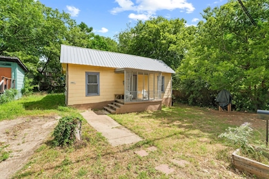 Bungalow-style home with metal roof and covered p
