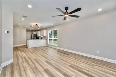 Images are of a model home  and may include custom design features not available in other homes. Family room with light wood-type flooring, recessed lighting, and a ceiling fan