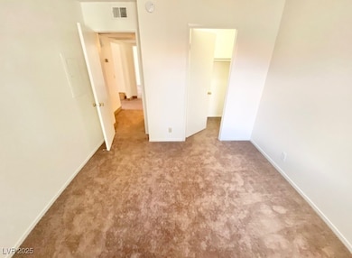 Unfurnished bedroom with carpet, a spacious closet