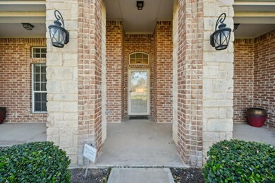 Property entrance featuring custom stone and brick