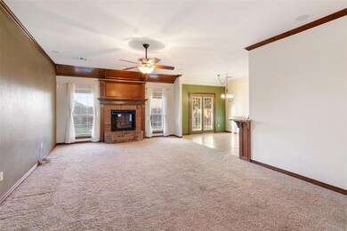 Unfurnished living room with ornamental molding, a