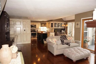 Kitchen w/ss appliances, wood floors, painted cabi