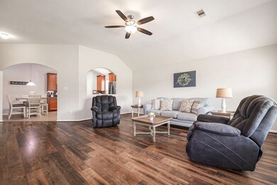 Spacious living room presents high ceilings and se
