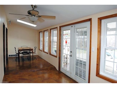 sunroom with skylights and ceiling fan off of back