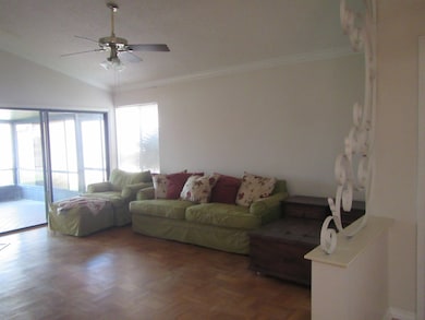 Living area with crown molding and ceiling fan