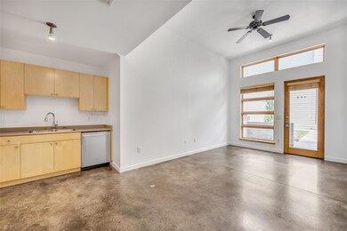 Kitchen featuring light brown cabinets, concrete 