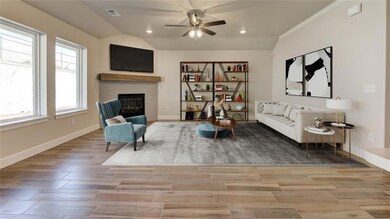 Living room featuring vaulted ceiling, baseboards,