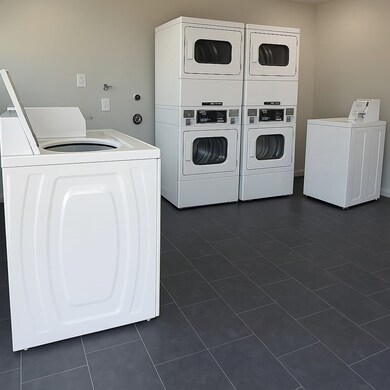 On-site laundry room with updated machines, clean